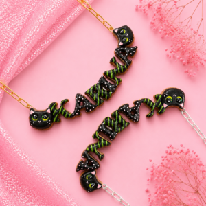 Collares personalizados de gatito negro alegre kawaii con nombres decorados, uno con cadena dorada y otro con cadena plateada.